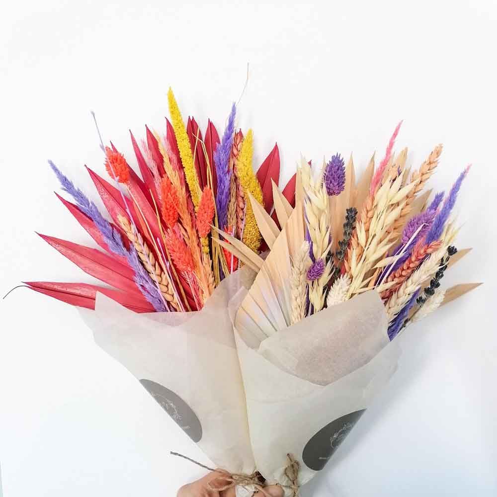 Two bunches of brightly coloured dried flowers