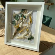 dried flowers in a picture frame